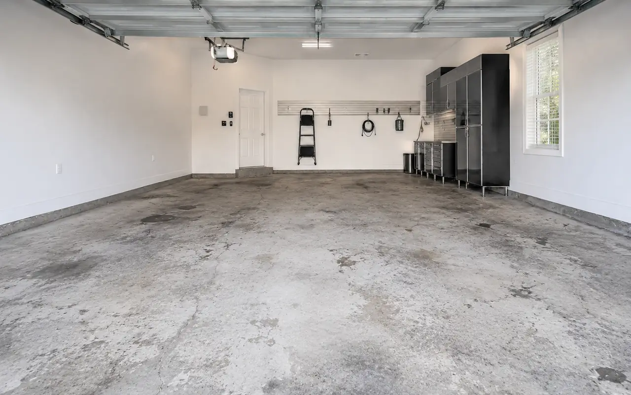 Worn bare concrete garage floor before coating